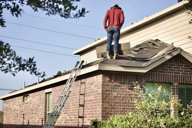 Professional roofer working on a residential roof in Whitehead Crossroads